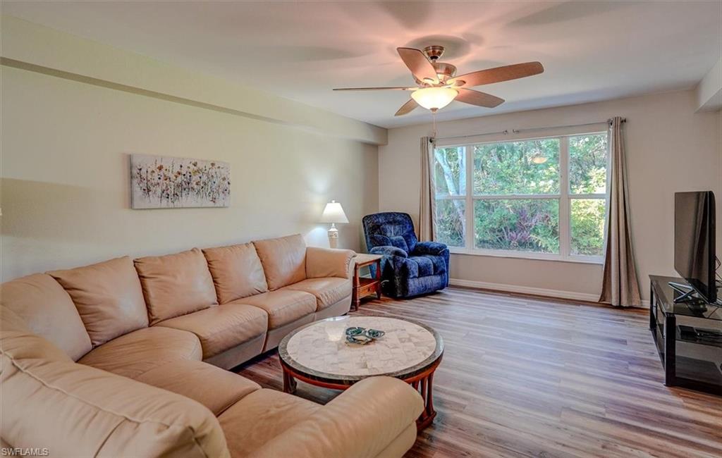 Living area with wood finished floors and a ceiling fan