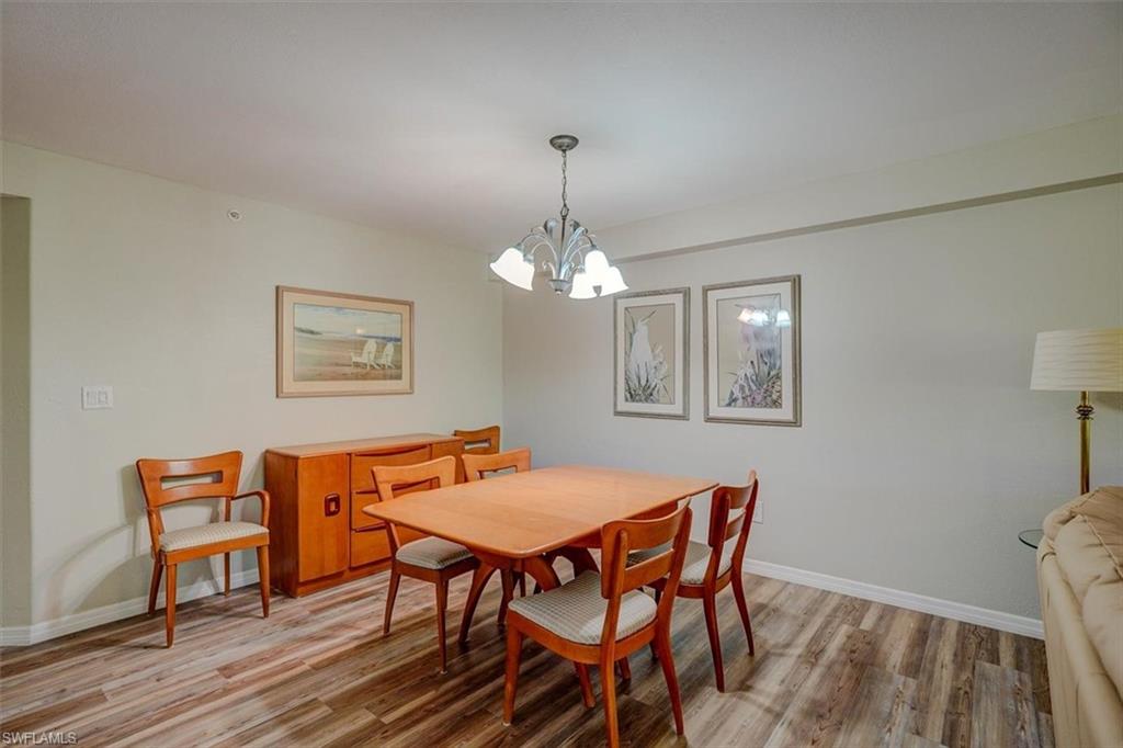 Dining space with light wood-style floors and a chandelier