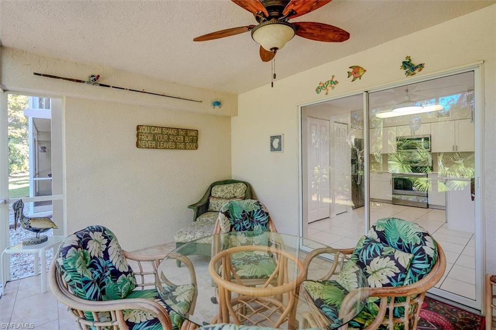 View of patio / terrace featuring a sunroom and a ceiling fan