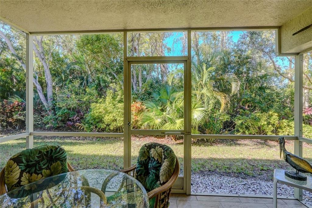 Sunroom / solarium with view of wooded area and healthy amount of natural light