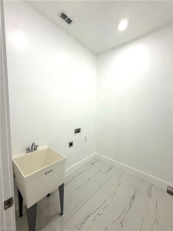 Laundry room with electric dryer hookup, light marble finish flooring, and recessed lighting