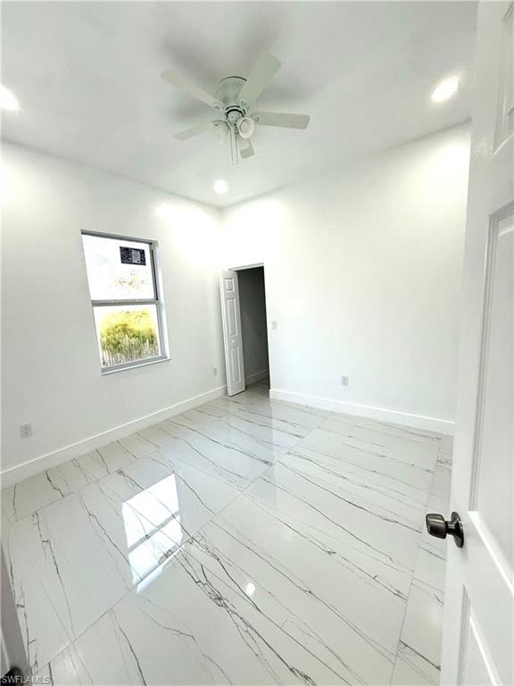 Spare room with recessed lighting, light marble finish floors, and ceiling fan