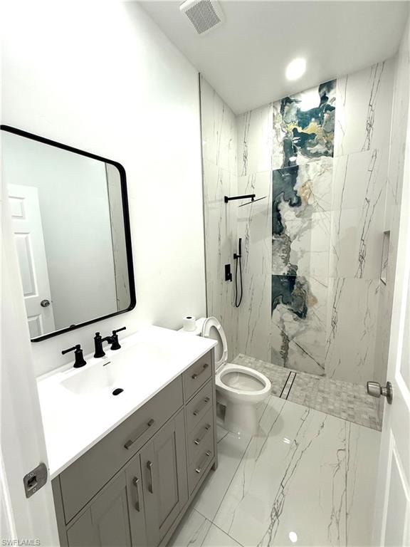 Full bathroom featuring light marble finish flooring, vanity, and a marble finish shower