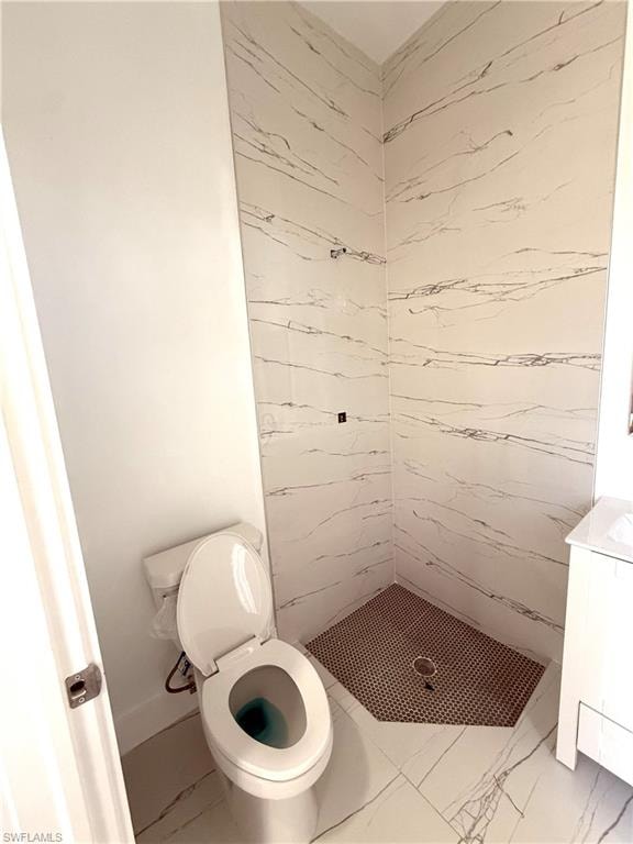 Full bathroom featuring a stall shower, vanity, and light marble finish floors