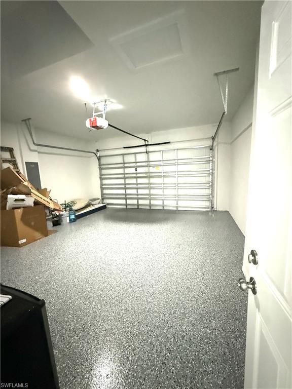 Garage with electric panel and a garage door opener