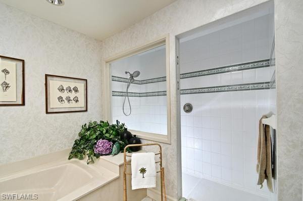 Bathroom with walk in shower and a bath