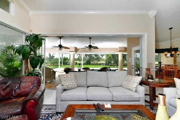Living room with ornamental molding and a chandelier