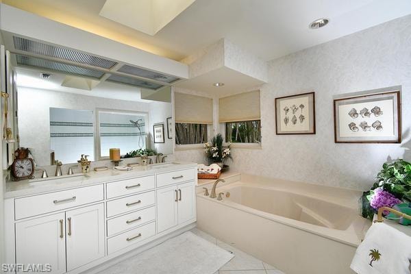 Bathroom featuring double vanity, a garden tub, and light tile patterned flooring