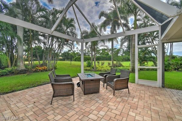 Sunroom / solarium with a patio area and an outdoor fire pit