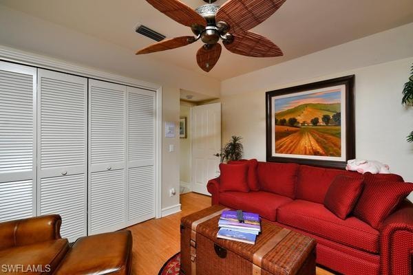 Living area featuring wood finished floors and a ceiling fan
