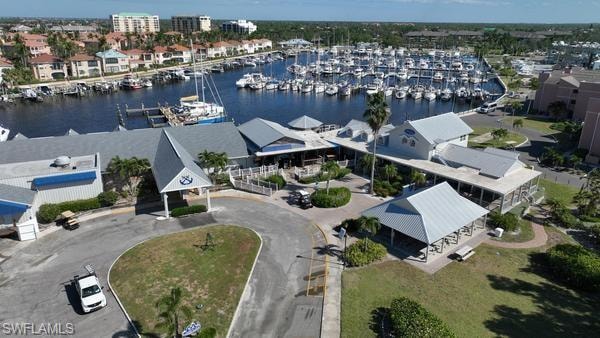 Drone / aerial view of numerous boat docks and a nearby body of water