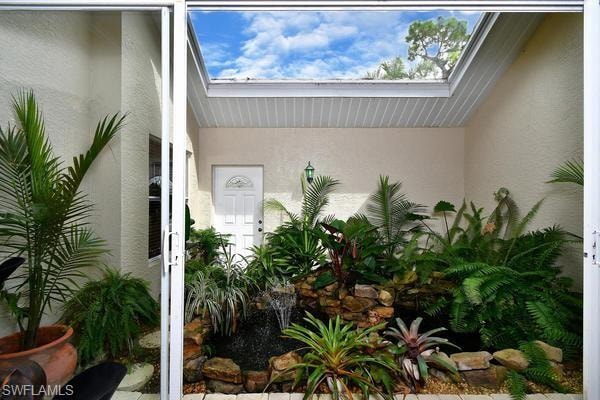 Property entrance with stucco siding