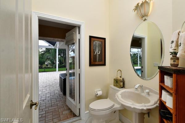 Half bath with toilet and baseboards