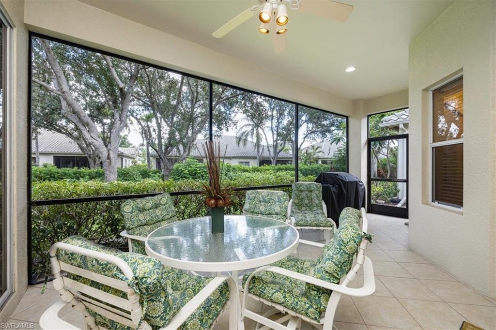 Sunroom / solarium featuring tile patterned flooring, a textured wall, and recessed lighting