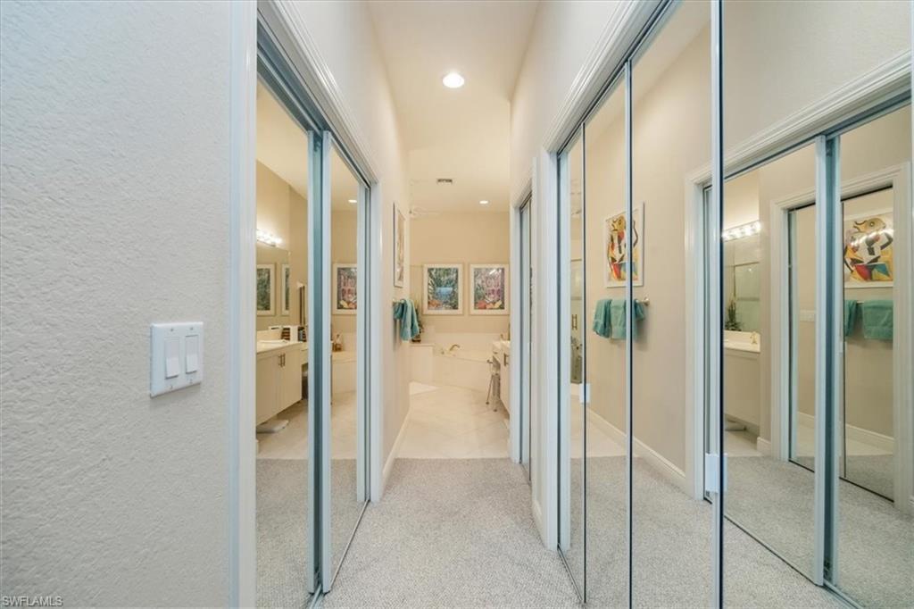 Hall featuring light carpet and recessed lighting