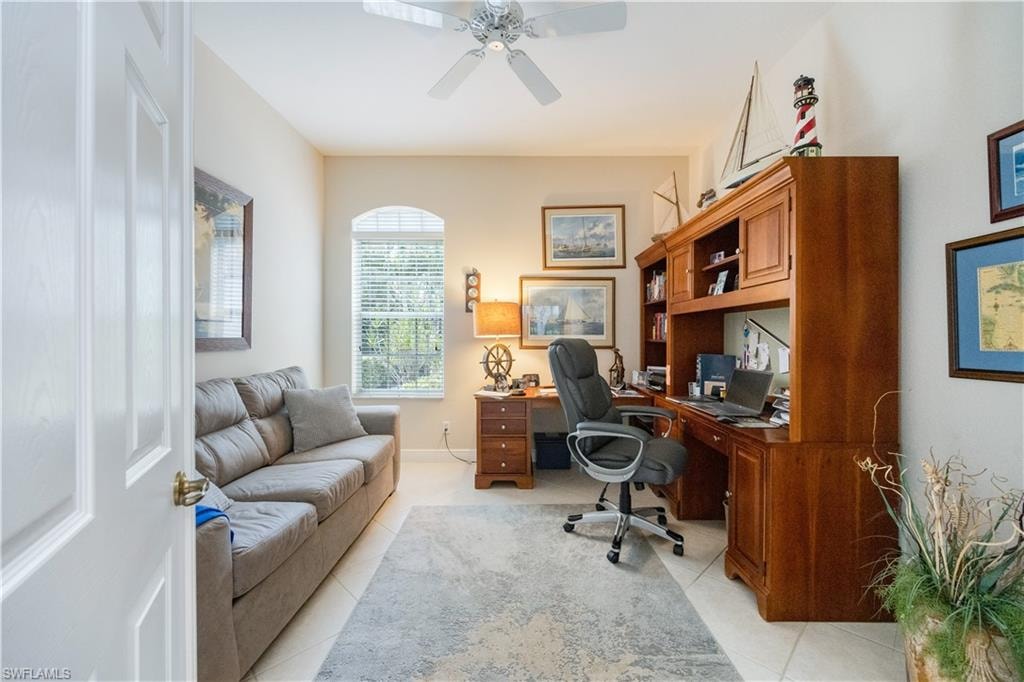 Office space featuring a ceiling fan and light tile patterned floors