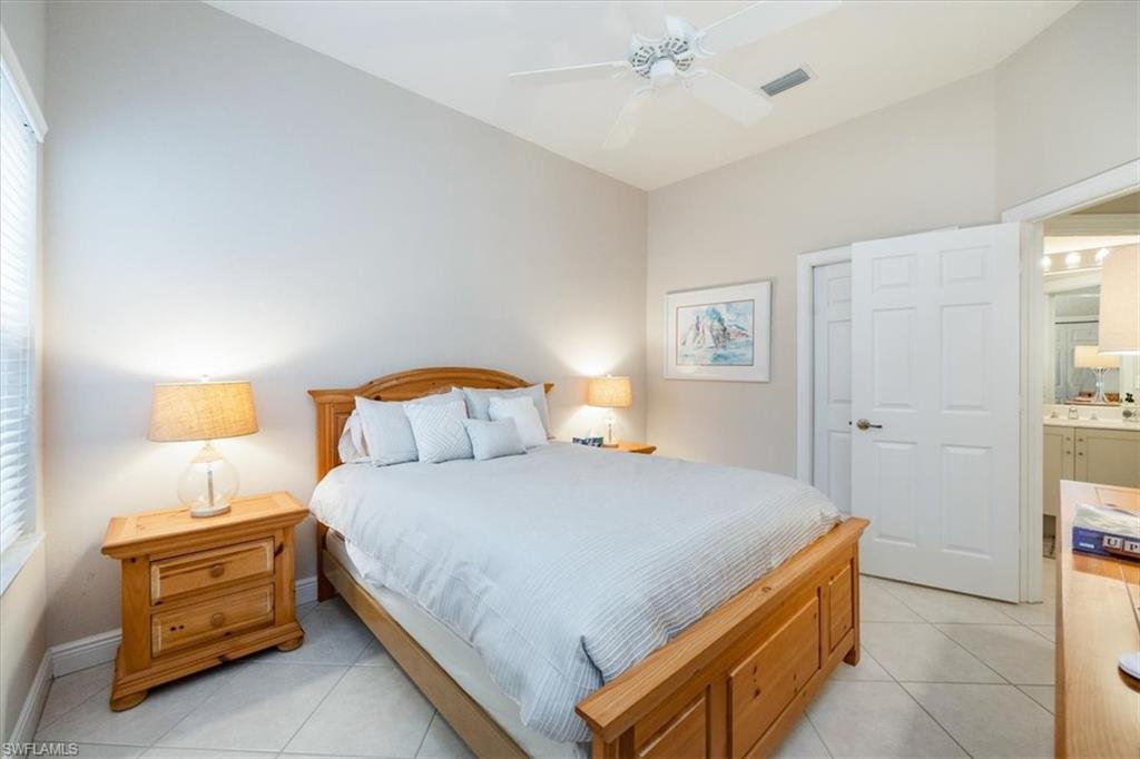 Bedroom with light tile patterned floors, a closet, and a ceiling fan