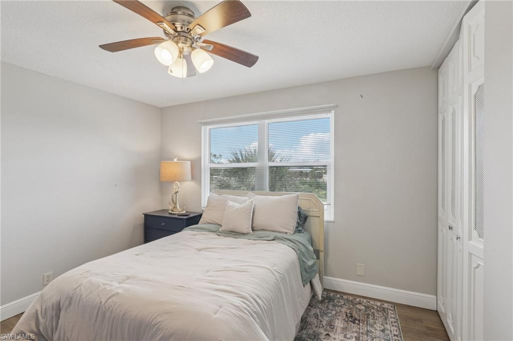 Bedroom with a closet, LVP floors, and ceiling fan