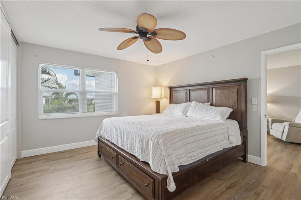 Bedroom featuring light LVP floors and ceiling fan