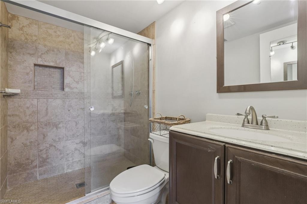 Updated bath with tiled shower and tiled floor