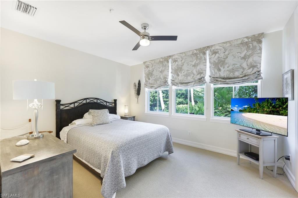 Bedroom featuring light carpet and ceiling fan