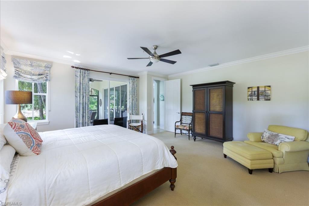 Carpeted bedroom featuring ornamental molding and ceiling fan