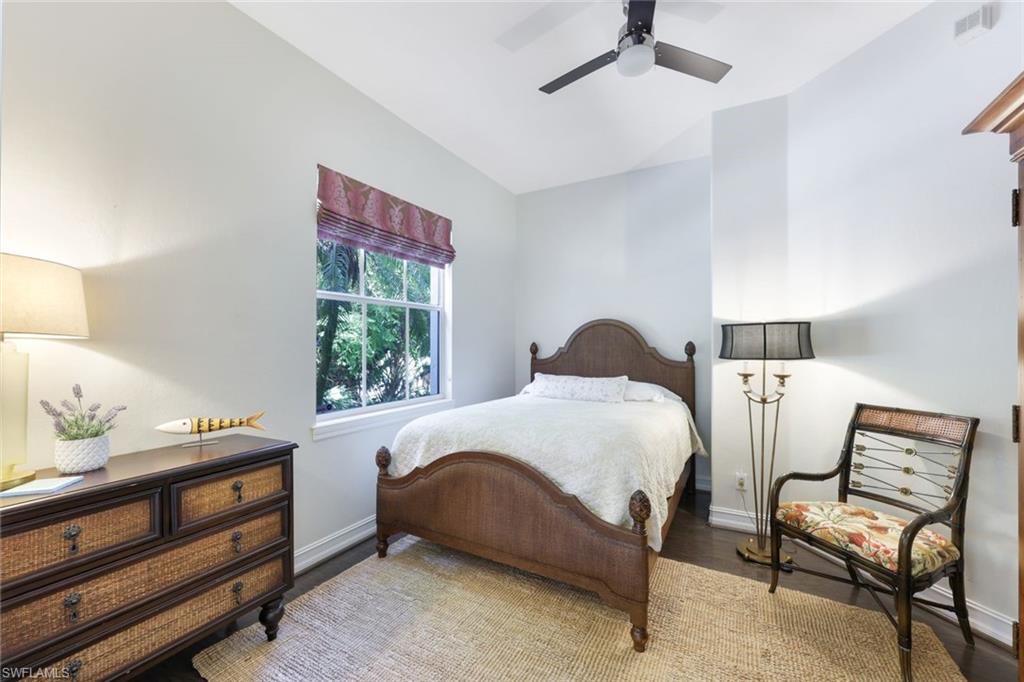 Bedroom with vaulted ceiling, ceiling fan, and hardwood / wood-style flooring