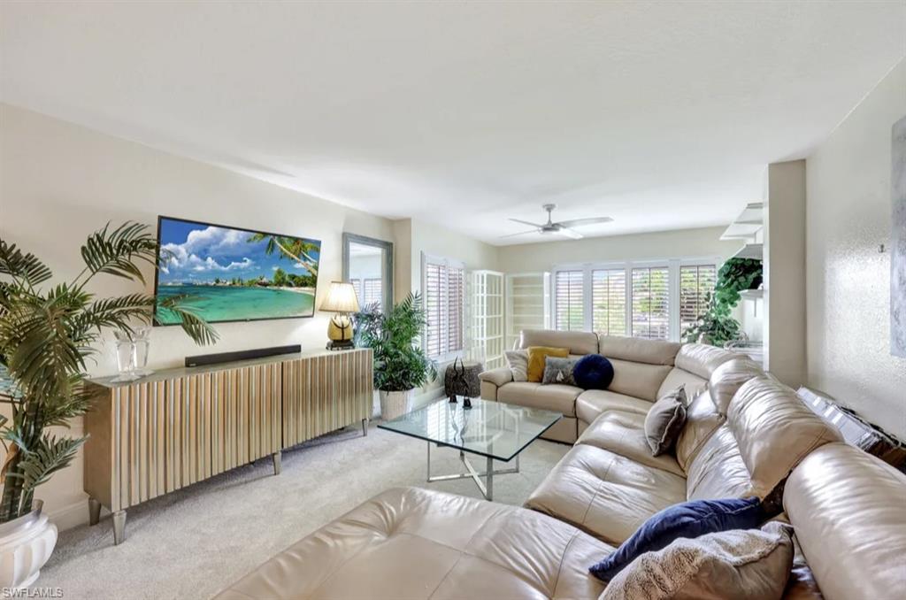 Living area with carpet flooring and ceiling fan