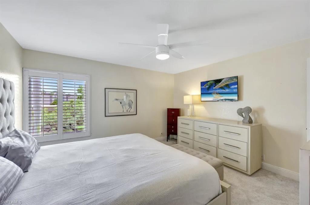 Bedroom featuring light carpet and a ceiling fan