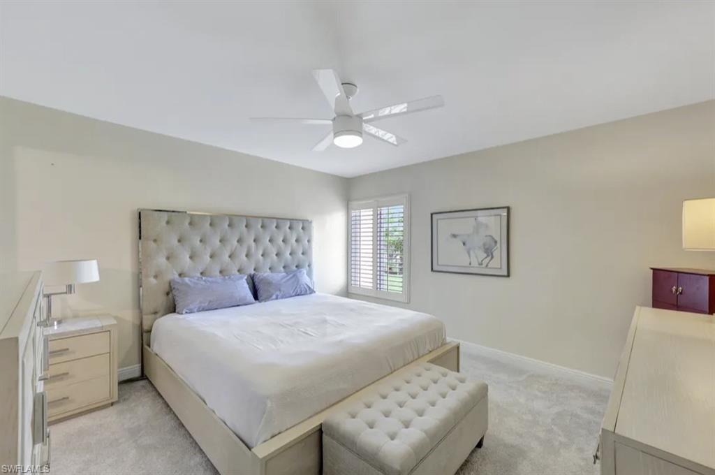 Bedroom with light carpet and ceiling fan