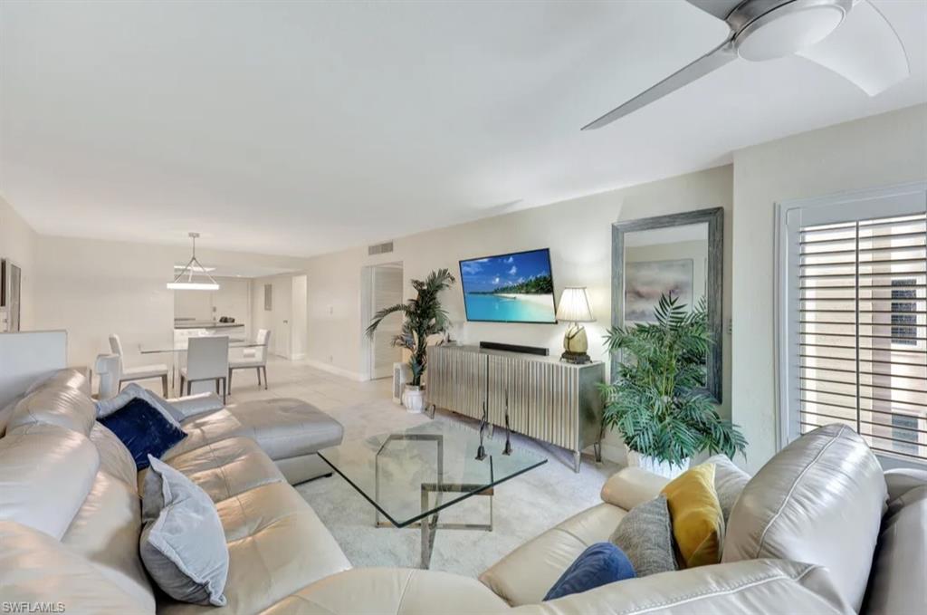 Living area with carpet floors and a ceiling fan