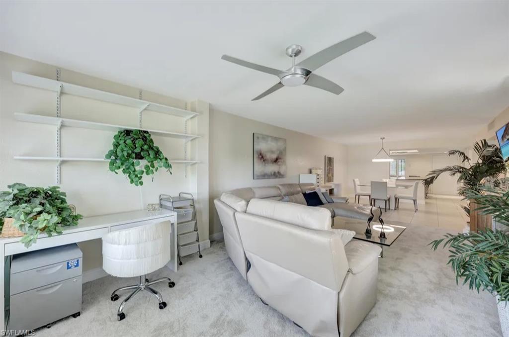 Tiled living area with carpet and ceiling fan