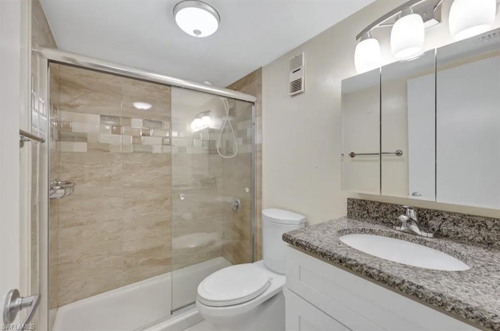 Full bathroom featuring vanity and a shower stall