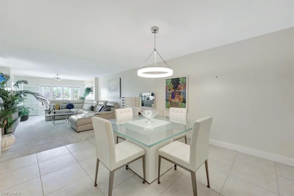Dining area featuring light colored carpet and light tile patterned floors