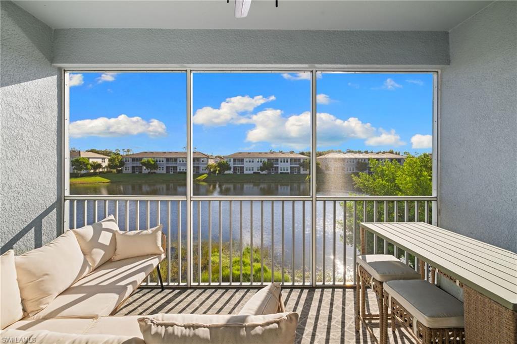 Sunroom / solarium featuring a water view