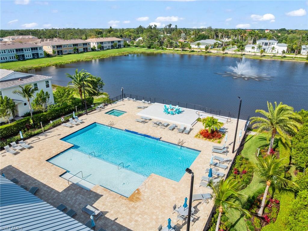 Community pool featuring a patio area and a water view