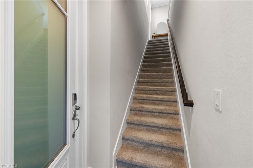 Stairway featuring baseboards and carpet