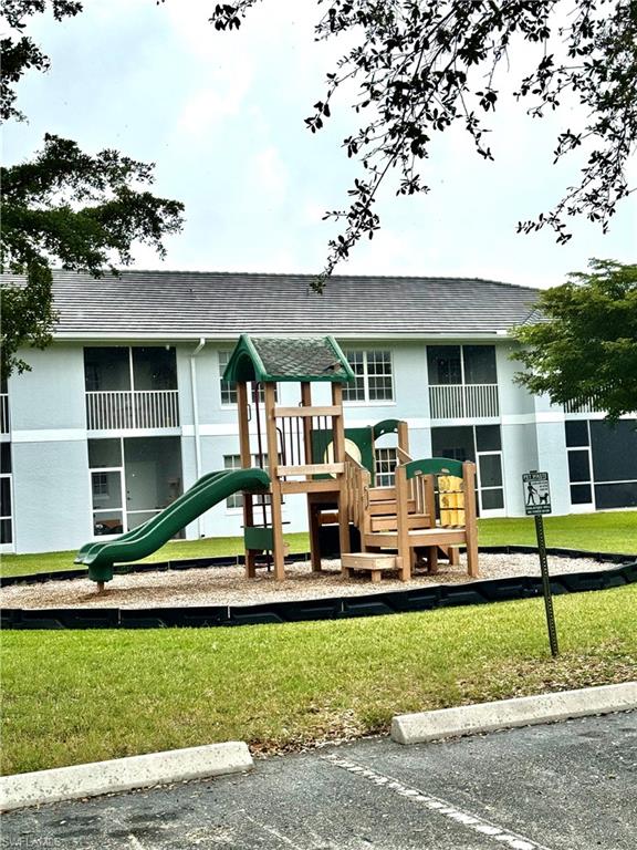 Community jungle gym featuring a lawn