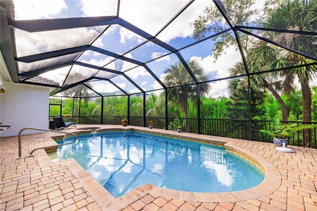 Outdoor pool with a sunroom, a lanai, and a patio