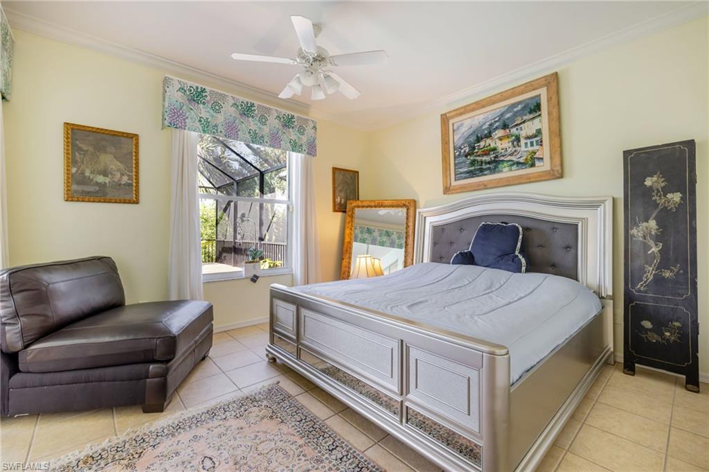 Bedroom featuring ornamental molding, a ceiling fan, and light tile patterned floors