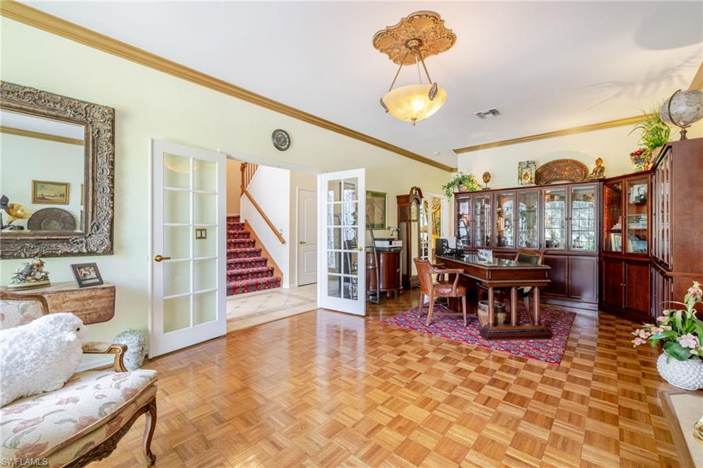 Dining room with french doors, stairway, and ornamental molding