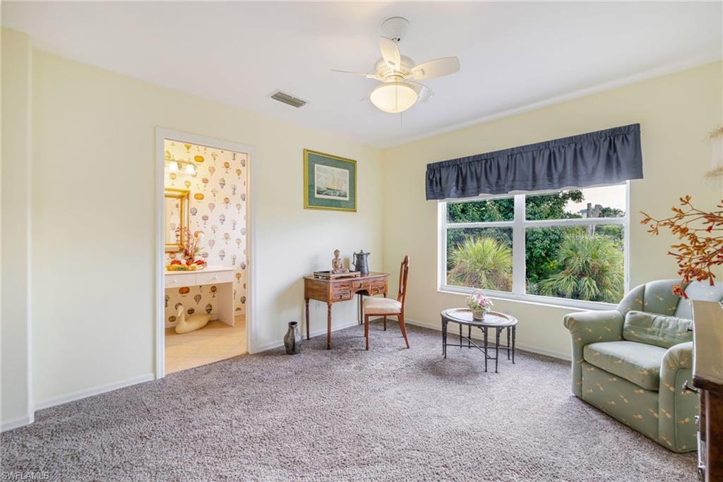 Living area featuring carpet floors and a ceiling fan