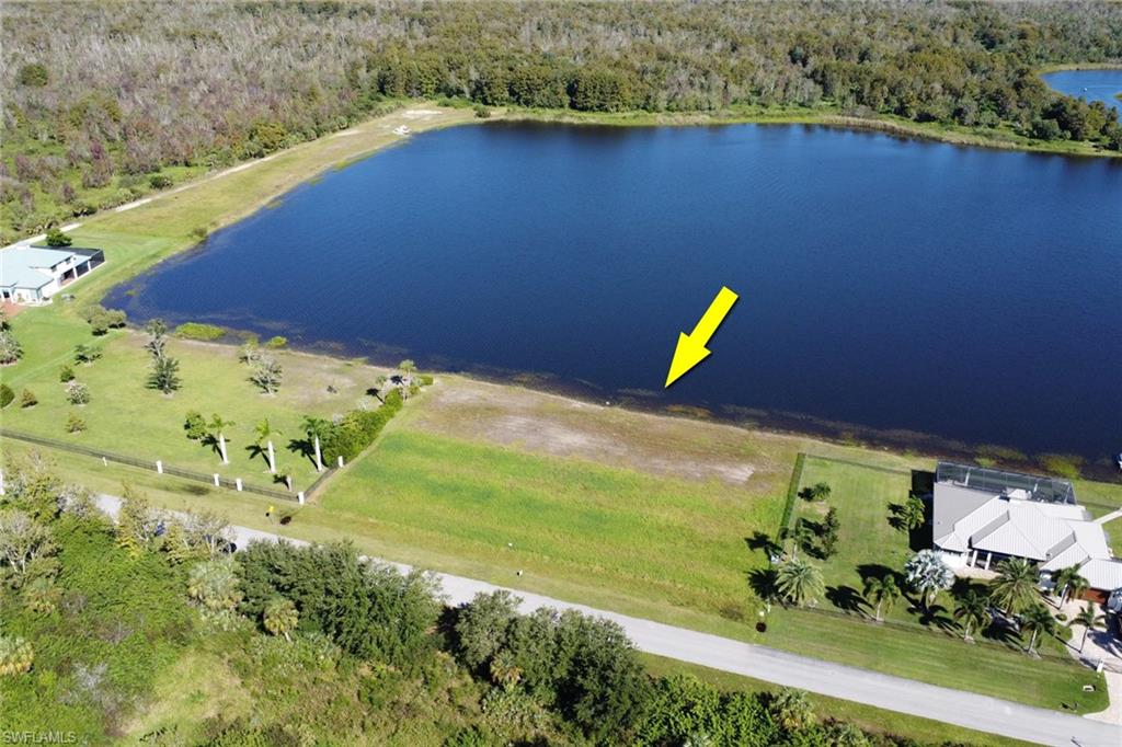 Aerial view of a heavily wooded area and a nearby body of water