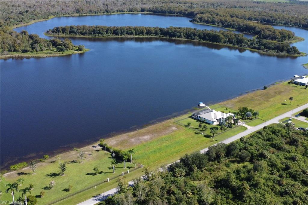 Aerial view of a nearby body of water and a heavily wooded area