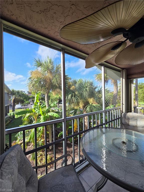 Balcony with a sunroom and a ceiling fan