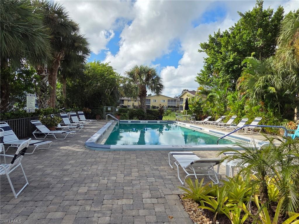 Community pool featuring a patio