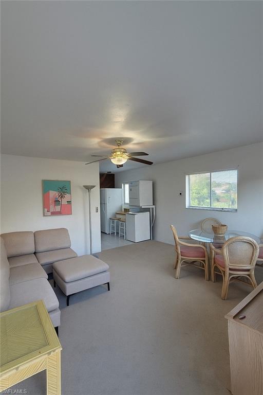 Living room with carpet and ceiling fan