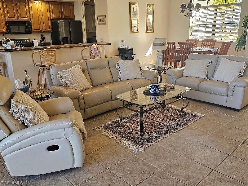 Living area with a chandelier and light tile patterned floors