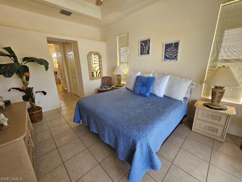 Bedroom with light tile patterned floors and a closet