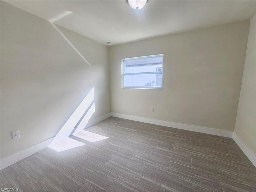 Unfurnished room with baseboards